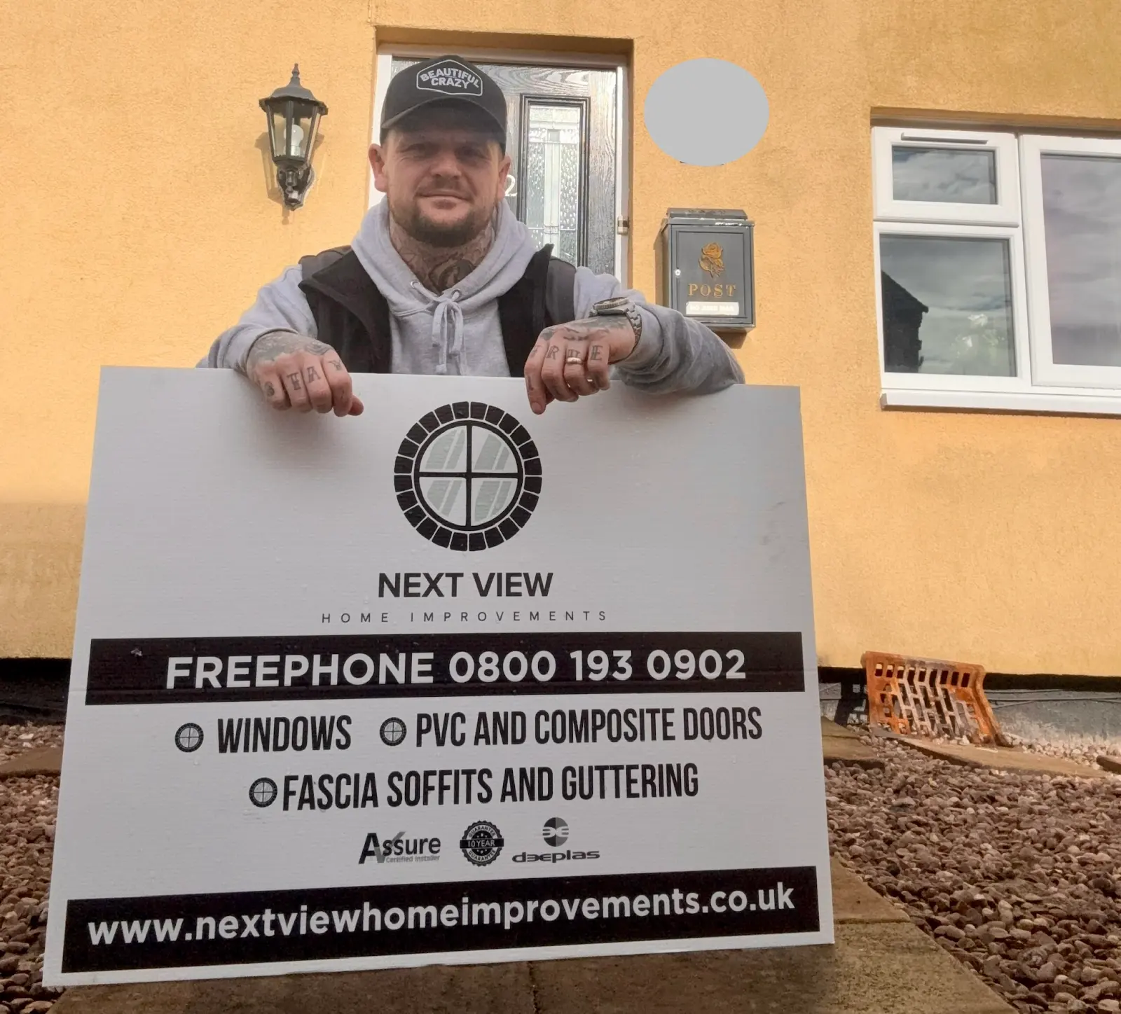 Next View Home Improvements team member with company signboard
